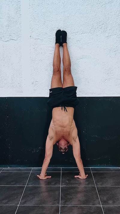 Wall assisted handstand