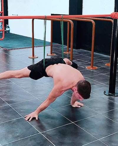 Elastic band assisted straddle planche