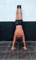 Assisted handstand with posterior pelvic tilt