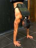 Weighted handstand push-up facing the wall